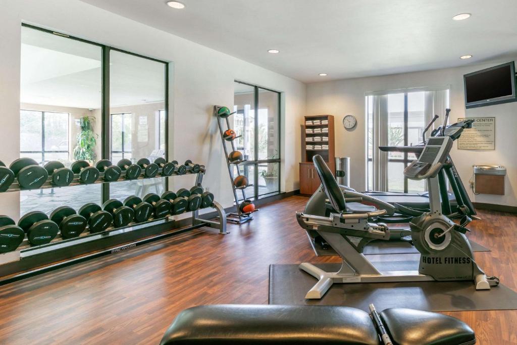 a gym with a treadmill and elliptical machines at Comfort Suites in Forrest City