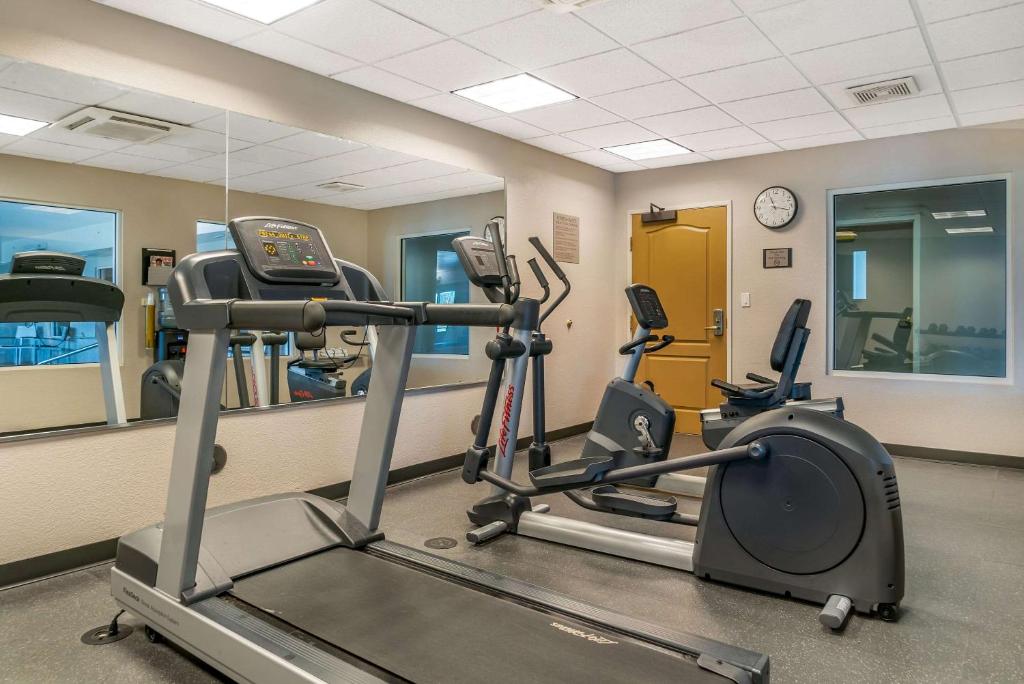 a gym with two tread machines and a mirror at Country Inn & Suites by Radisson, Rossford - Toledo South in Rossford