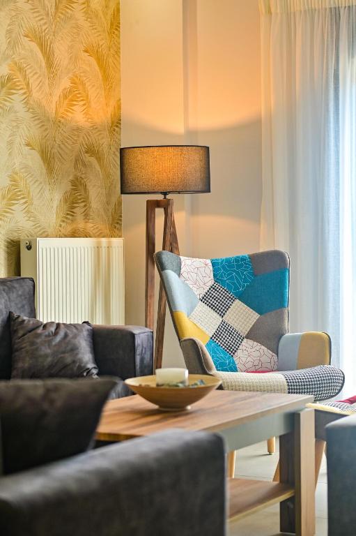 a living room with a couch and a table at Nychome in Ayía Marína