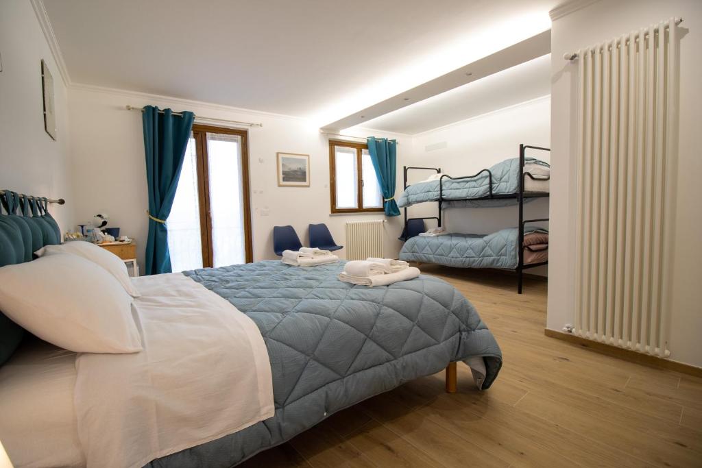 Łóżko lub łóżka w pokoju w obiekcie La Casa del Postino