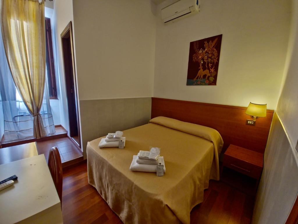 Postel nebo postele na pokoji v ubytování Hotel Azzurra