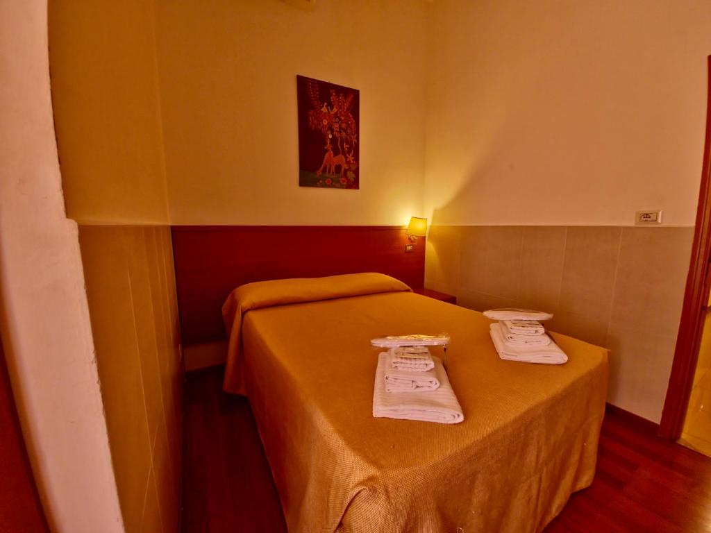 Postel nebo postele na pokoji v ubytování Hotel Azzurra