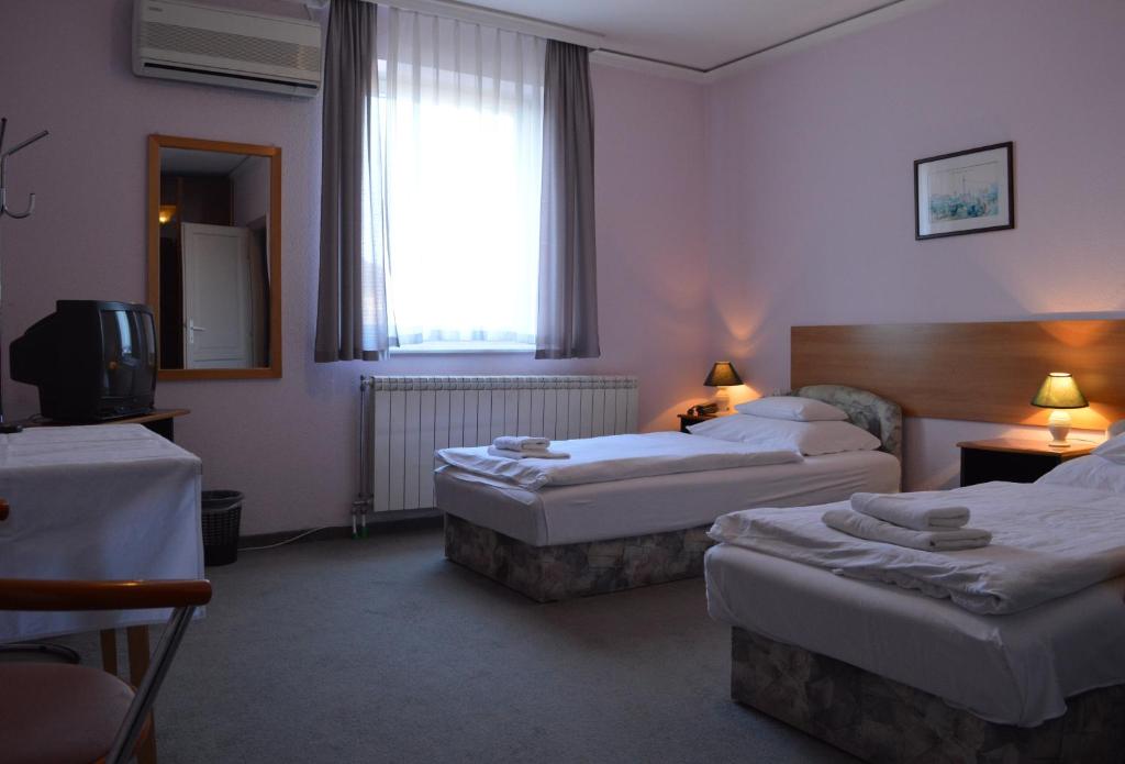 Postel nebo postele na pokoji v ubytování Apollo Motel