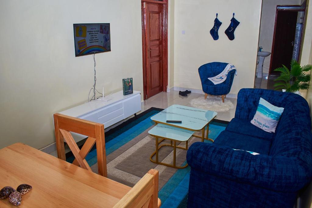 a living room with two chairs and a table at Cessy Haven Cool Homes in Kakamega