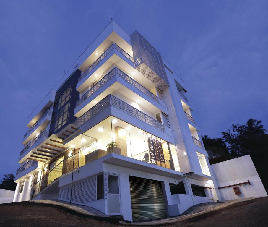 a large white building with lights on it at Park Connect in Cochin