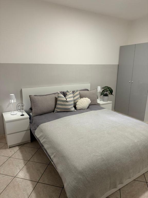 a bedroom with a large bed with two night stands at Apartment Cuore del Lido in Lignano Sabbiadoro
