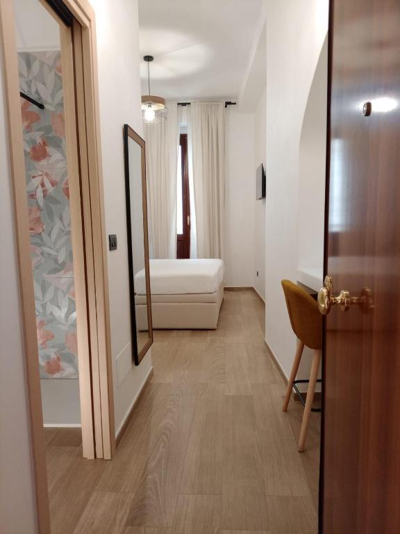 a hallway with a room with a couch and a mirror at Hasu Rental Rooms in Trani