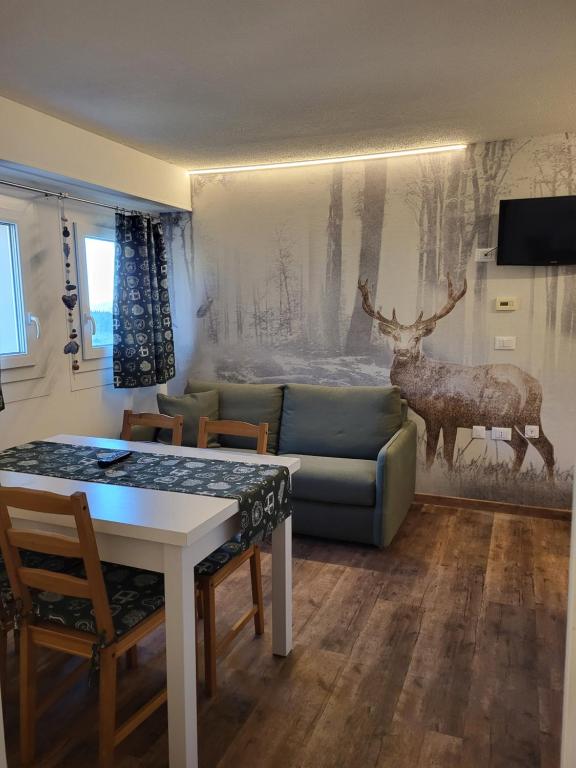 a living room with a couch and a table at Appartamento San Bartolomeo in Passo del Tonale