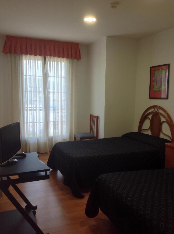 Postel nebo postele na pokoji v ubytování Hostal Las Eras