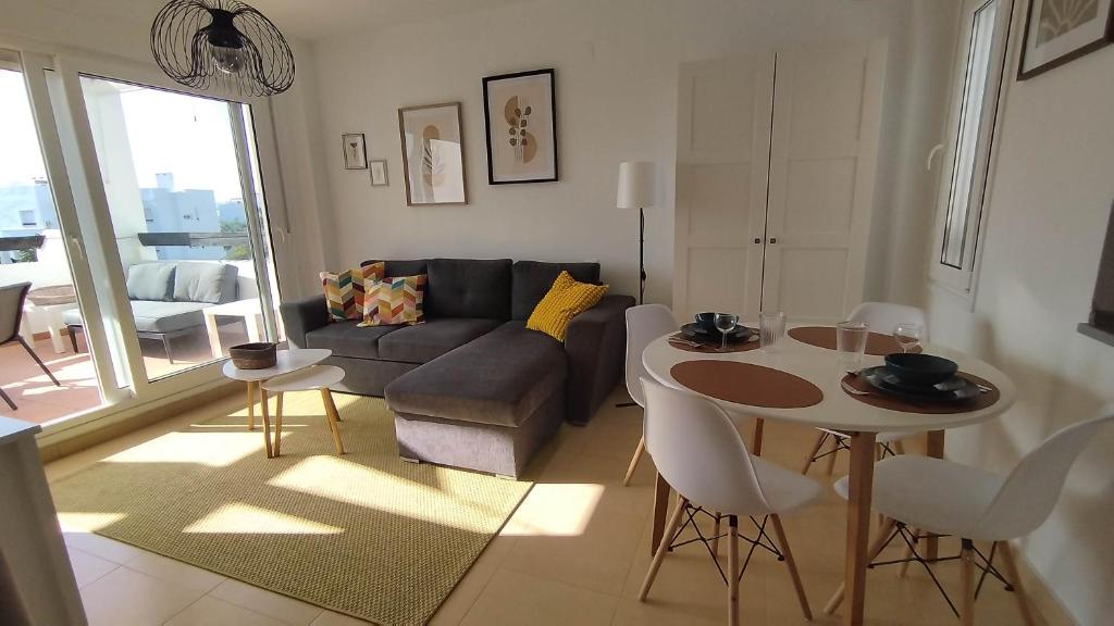 a living room with a couch and a table at Sunnydays in Roldán