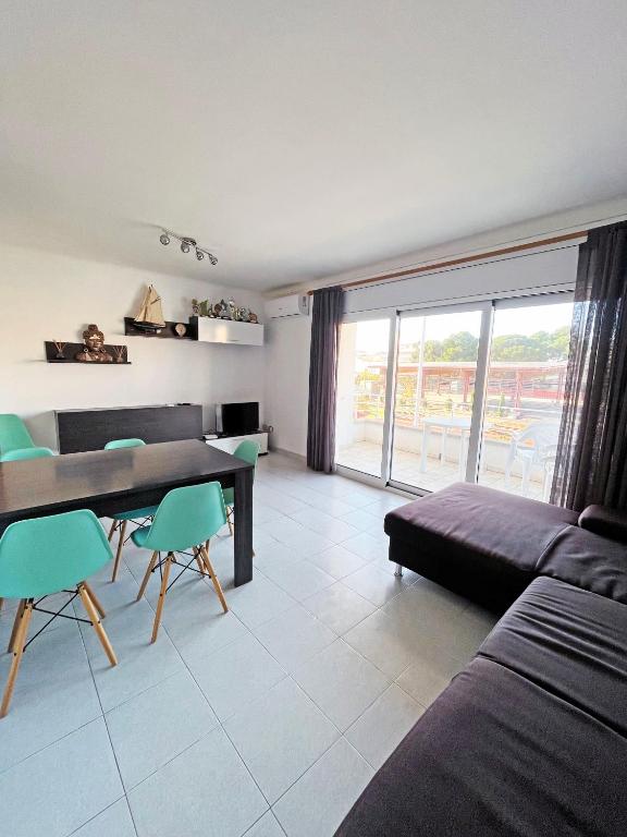 a living room with a table and chairs and a couch at Apartamento de 3 habitaciones en el centro in L'Escala