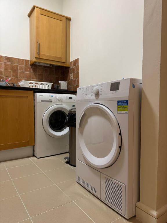a kitchen with a washing machine and a washer at The Spencer Suite in Dublin