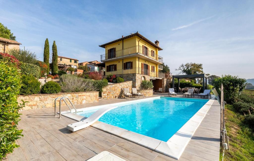 a villa with a swimming pool in front of a house at Lovely Home In Castiglione Del Lago in Castiglione del Lago