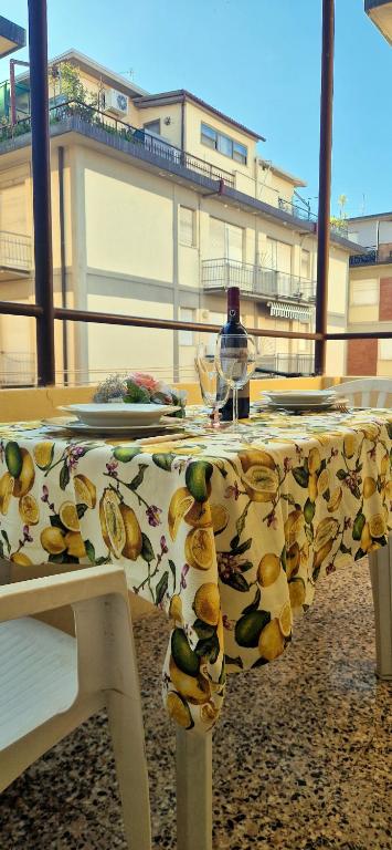 a table with a table cloth with fruit on it at Summer apartment in Viareggio