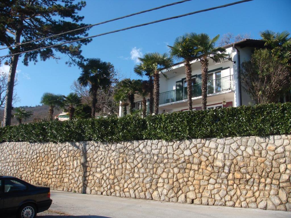 a house behind a stone wall at Apartment Leon and Leona in Opatija