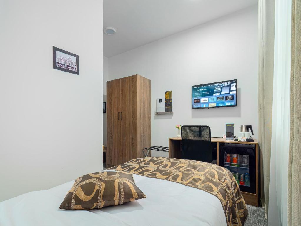 Postel nebo postele na pokoji v ubytování TA Collection Hotel