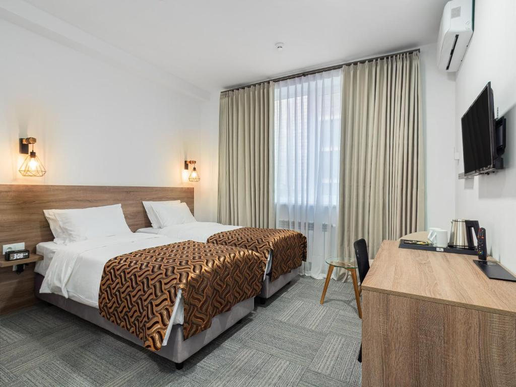 Postel nebo postele na pokoji v ubytování TA Collection Hotel