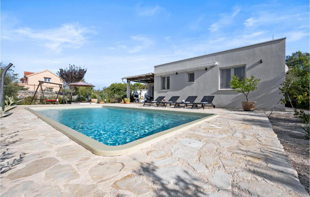 a swimming pool in front of a house at Stunning Home In Jadrija in Jadrija