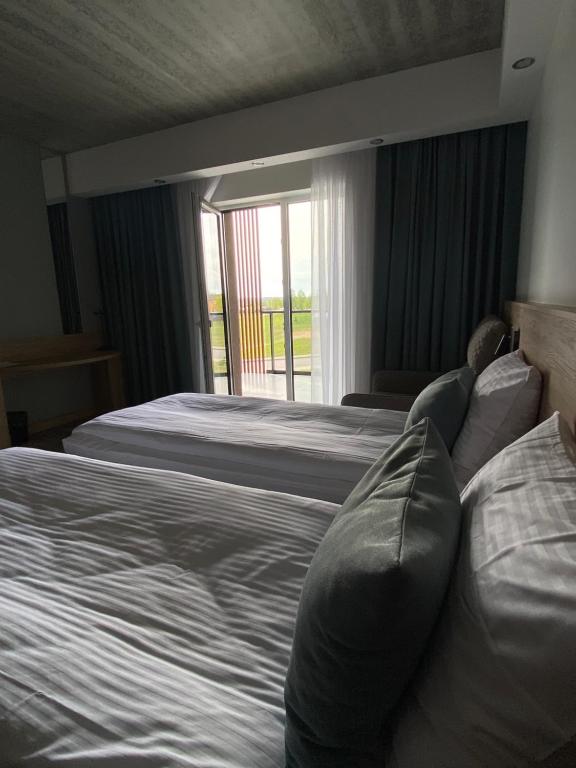 Postel nebo postele na pokoji v ubytování Molėtai Hotel