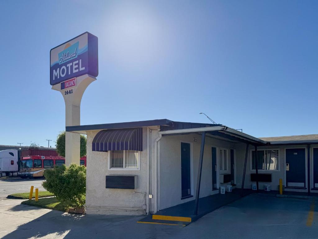 a motel with a sign on top of a building at Hiland Motel in Long Beach