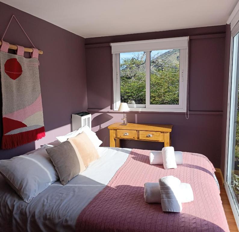 a bedroom with a large bed and a window at Aizeder - Eco Container in El Chalten