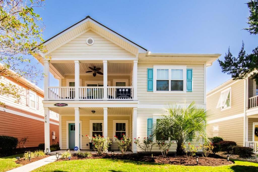 a large white house with a balcony at Aloha Breeze Pet Friendly House Near Beach in Myrtle Beach