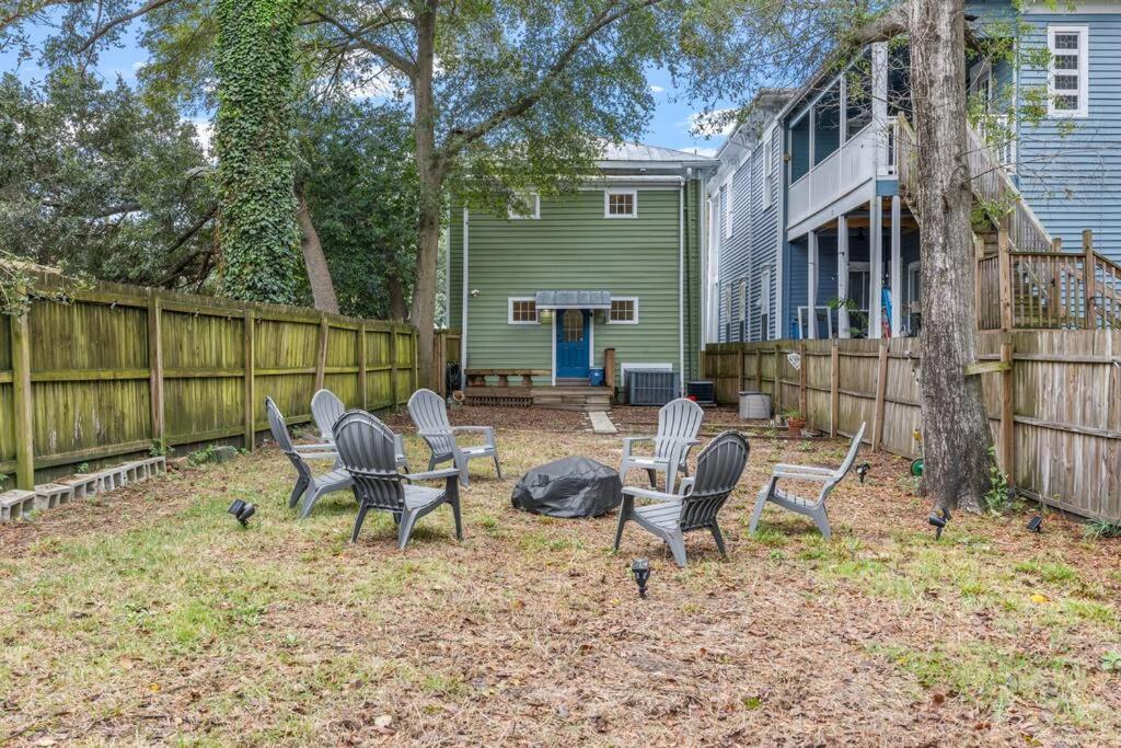 a group of chairs in a yard next to a fence at Half Off SALE! Downtown Home with King Bed FirePit Free Parking and Huge Back Yard Filming Allowed in Wilmington
