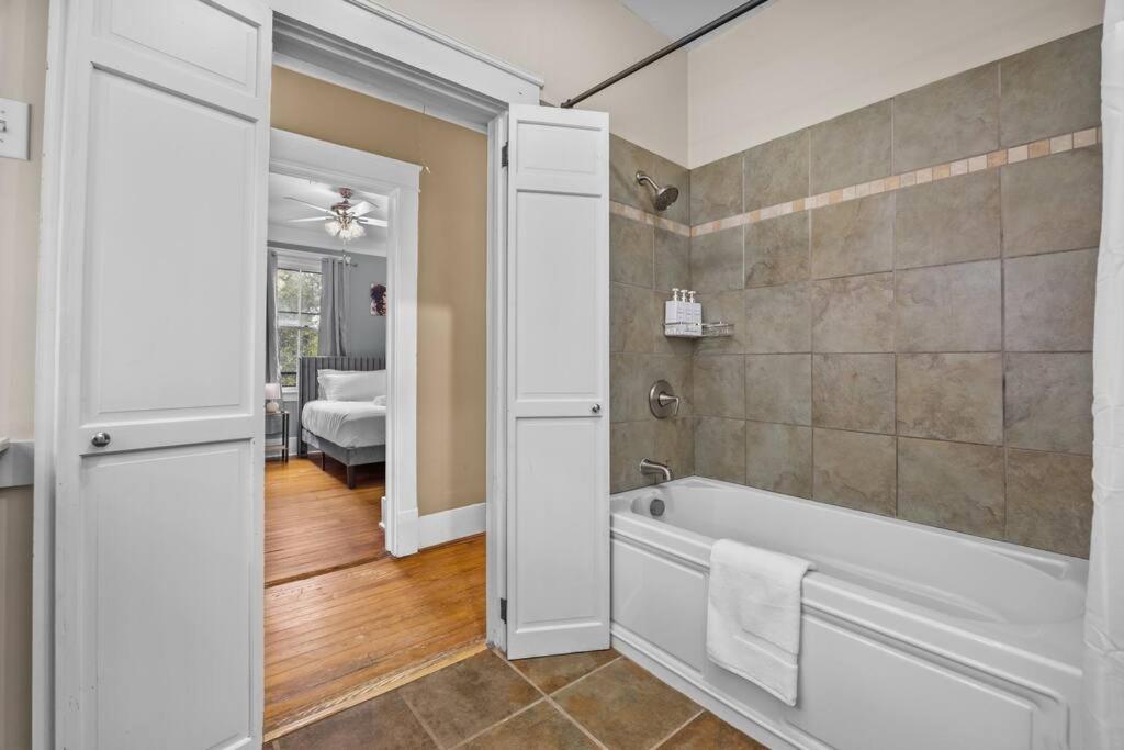 a bathroom with a bath tub and a shower at Half Off SALE! Downtown Home with King Bed FirePit Free Parking and Huge Back Yard Filming Allowed in Wilmington