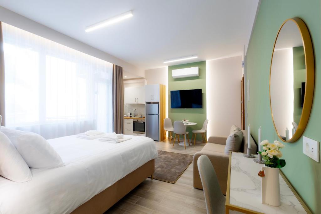 a bedroom with a large white bed and a mirror at CityLuxe Center Ioannina in Ioannina