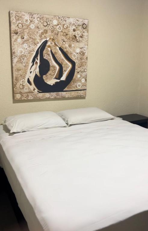 Cama ou camas em um quarto em Pousada Aquarela de Bombinhas
