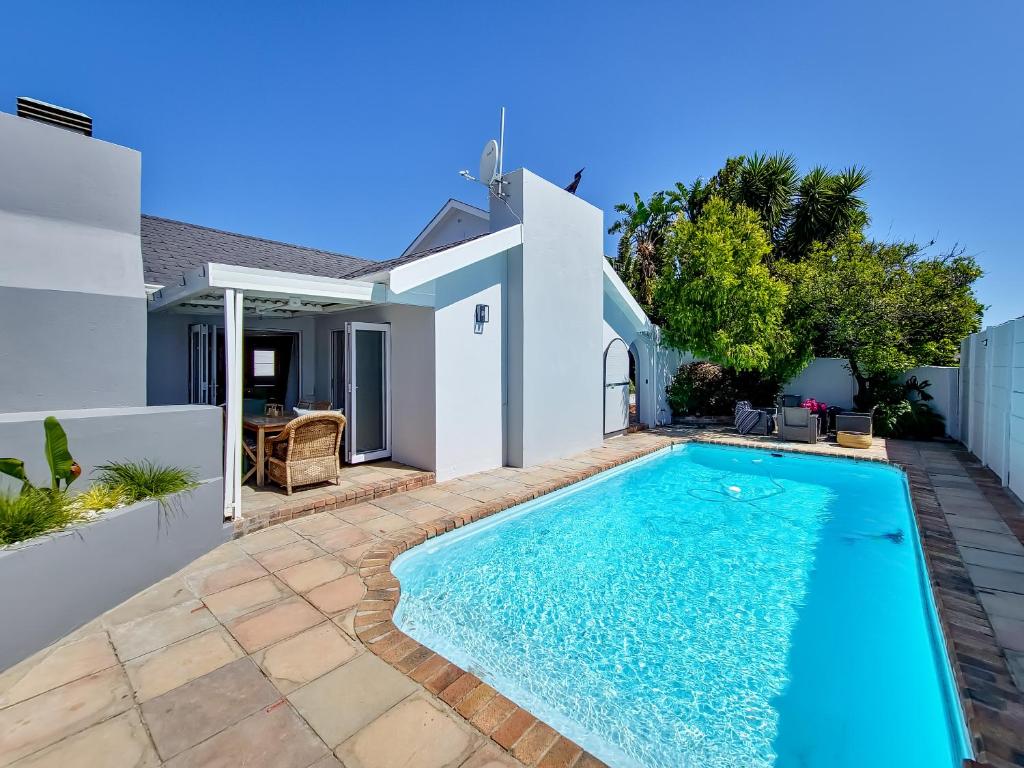 a swimming pool in the backyard of a house at Strand Boat House in Cape Town