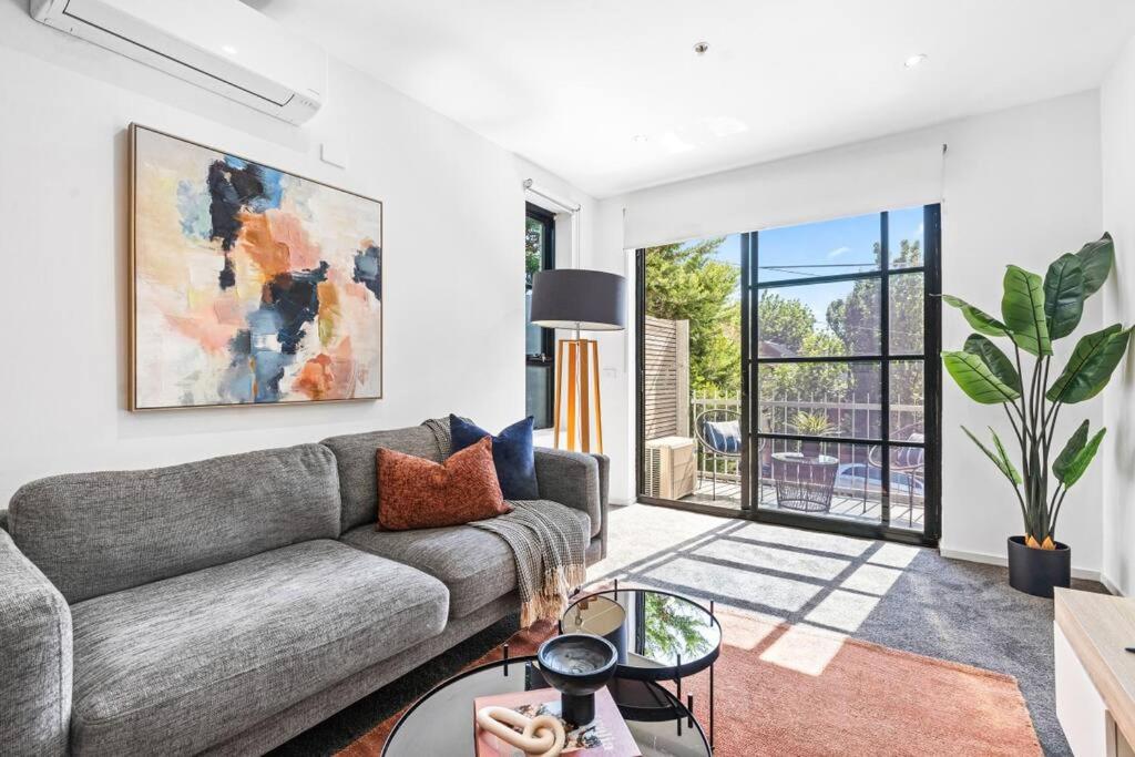 a living room with a couch and a table at Barkly Beachside Escape in Melbourne