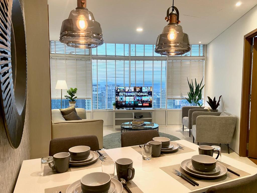 a dining room and living room with a table and chairs at Stella Maison KLCC in Kuala Lumpur