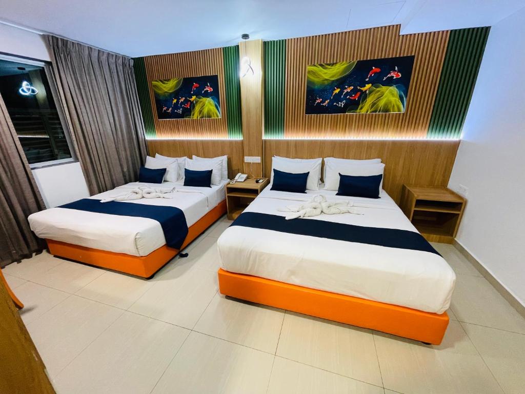 Postel nebo postele na pokoji v ubytování ESSY Hotel KL Sentral