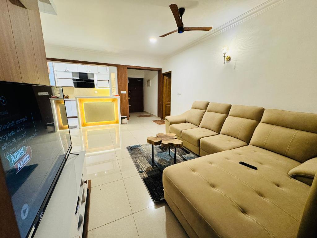 a living room with a couch and a flat screen tv at 6Floor in society Ecity ph2 Near TCS Tech Mahindra in Bengaluru
