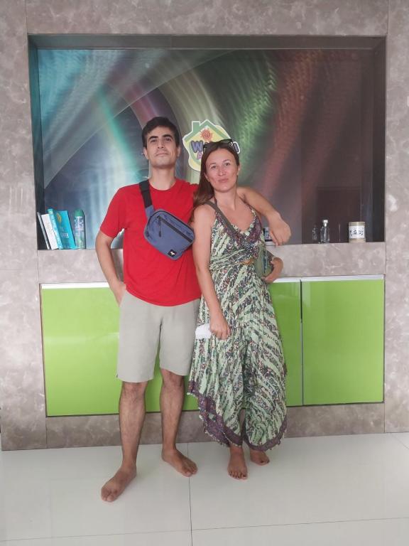 a man and a woman standing in a kitchen at WakakaPackers in Kuala Lumpur
