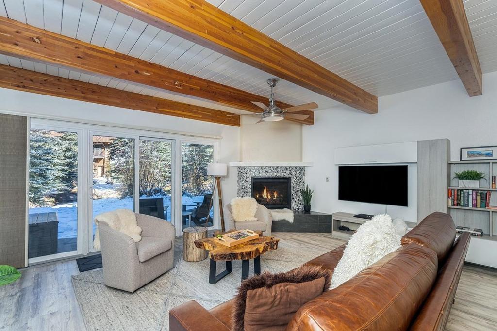 a living room with a couch and a fireplace at Riverside A03 condo in Telluride