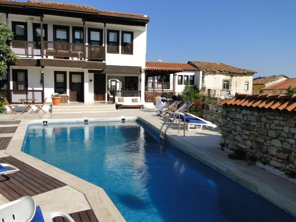 a swimming pool in front of a house at Villa Konak Hotel in Kusadası