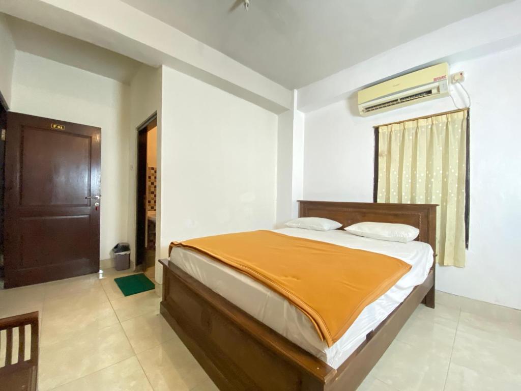Postel nebo postele na pokoji v ubytování New Wijaya Hotel