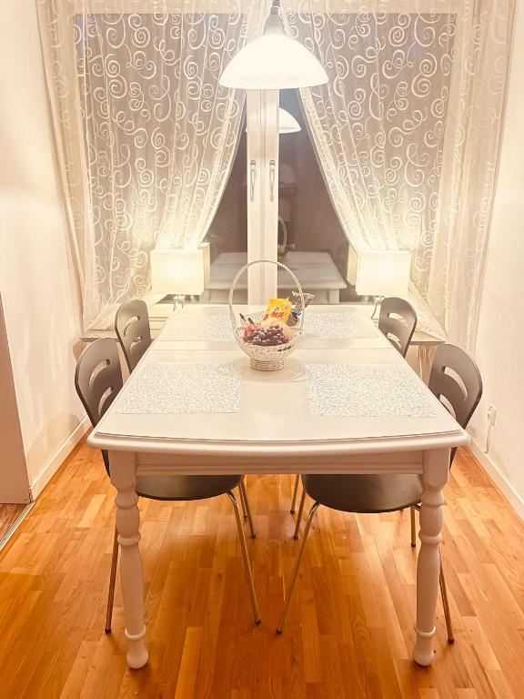 a white table with a bowl on top of it at Apartment in Skellefteå
