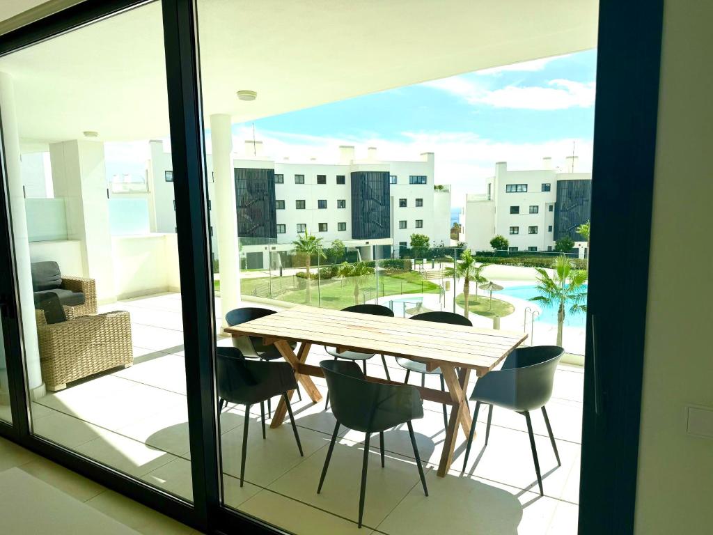 a table and chairs on a balcony with a view at higuerón Aqualis in Torremuelle