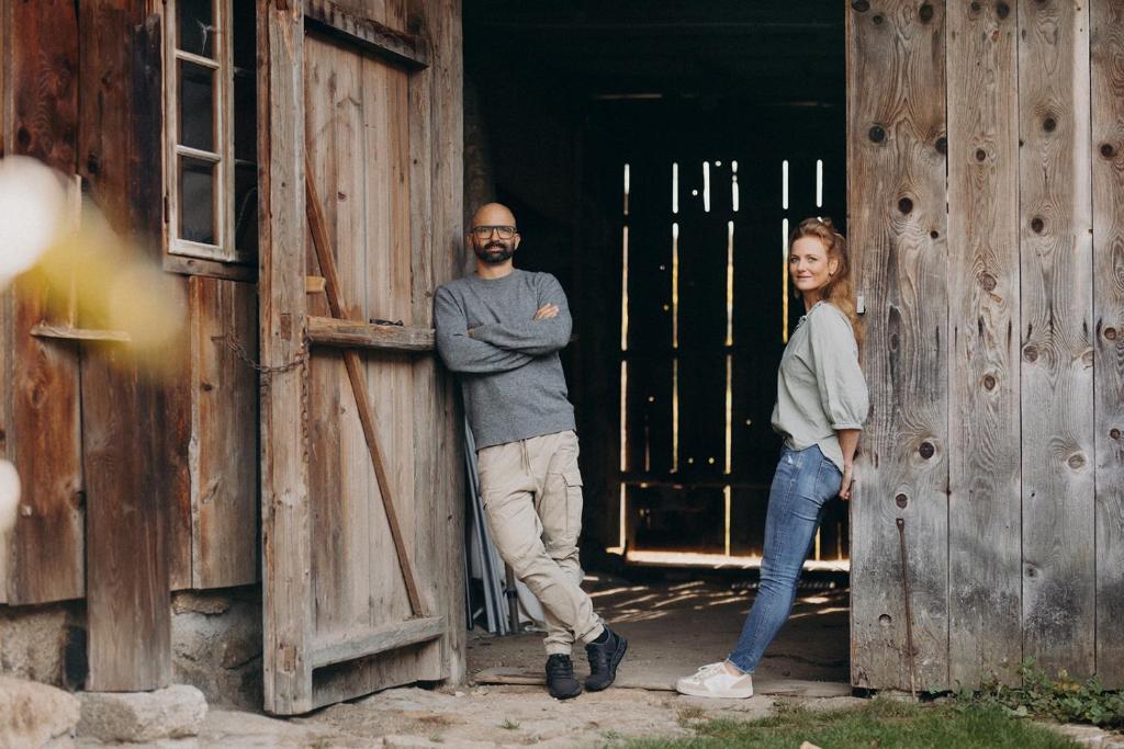 a man and a woman standing in an open door at Aigen 13 - Dreiviertelhof im Waldviertel in Aigen