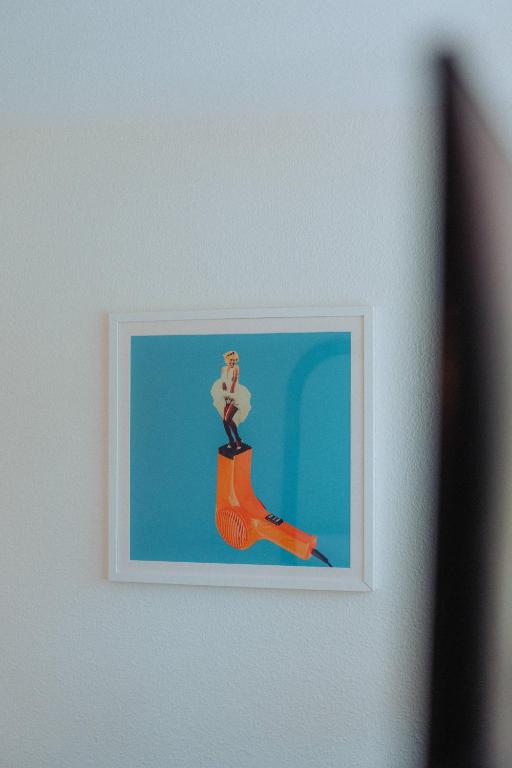 a picture of a woman on a orange shoe on a wall at Kyriad Cannes - Mandelieu in Cannes