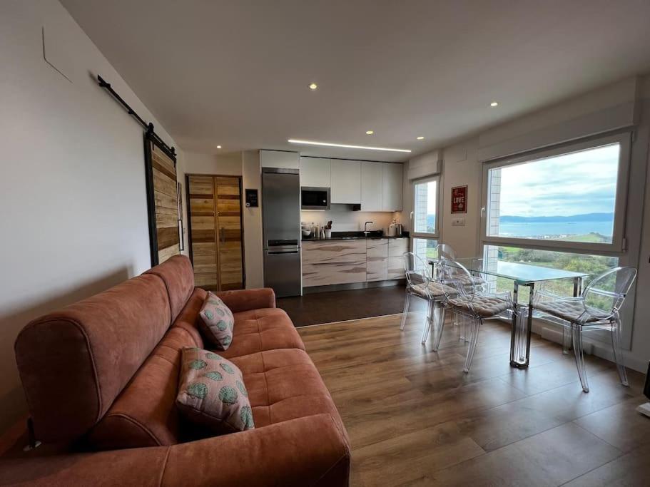 a living room with a couch and a glass table at Apto vacacional en Barrica in Barrika