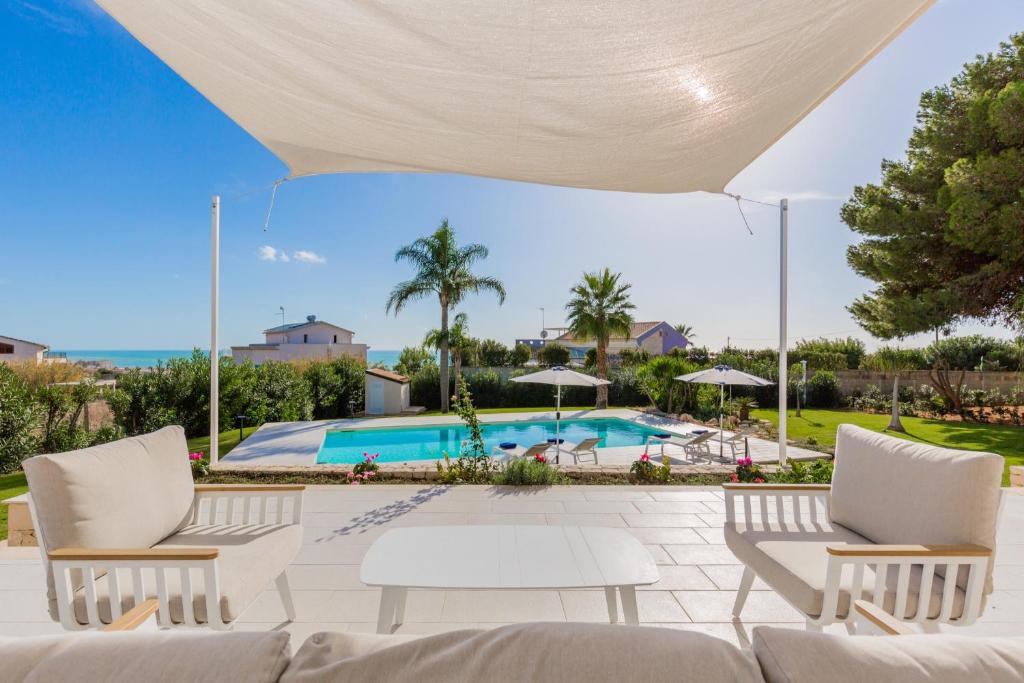a view of the pool from the patio of a villa at Dione Villa Mare di Ponente in Donnalucata