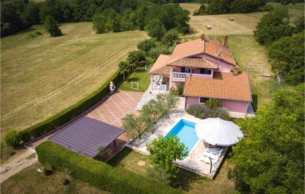 an aerial view of a house with a swimming pool at Holiday Home Livaki Iv in Muntrilj