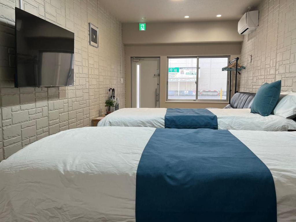 Postel nebo postele na pokoji v ubytování Comfy House Namba
