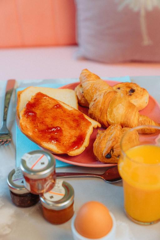 a plate of food with bread and eggs on a table at Kyriad Cannes - Mandelieu in Cannes