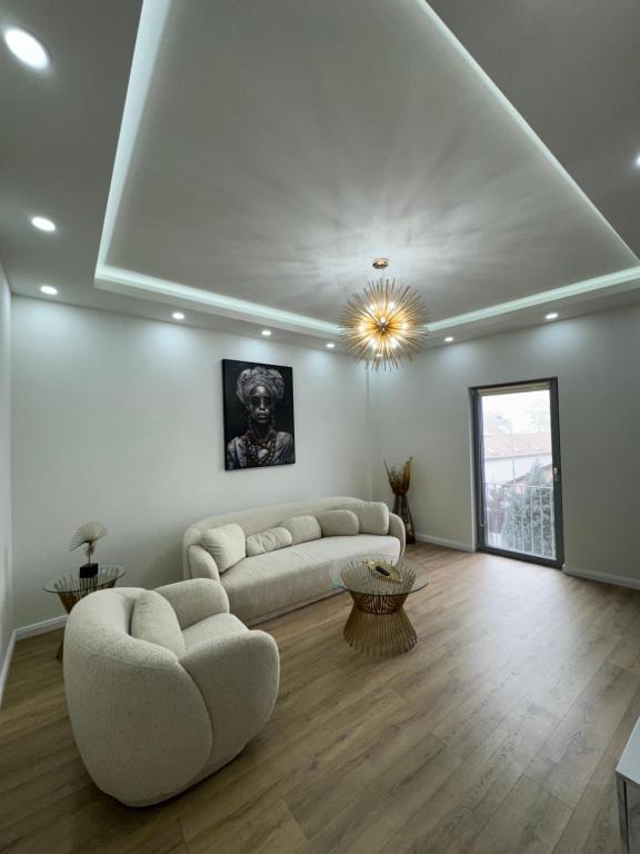 a living room with a couch and a table at Avenue View - Julie Apartment in Blaj