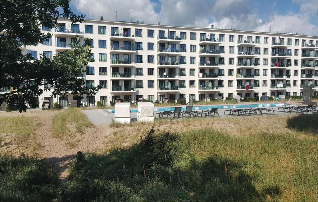 a large white building with chairs in front of it at Prince in Binz